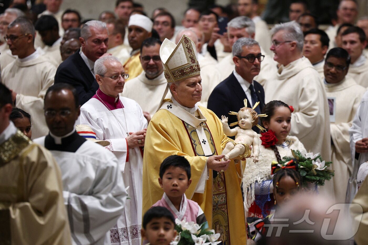 본문 이미지 - 교황 레오 14세가 24일(현지시간) 성탄 전야 미사를 위해 아기 예수 인형을 들고 성 베드로 대성당에 입장하고 있다. 2025.12.24 ⓒ 로이터=뉴스1 ⓒ News1 강민경 기자