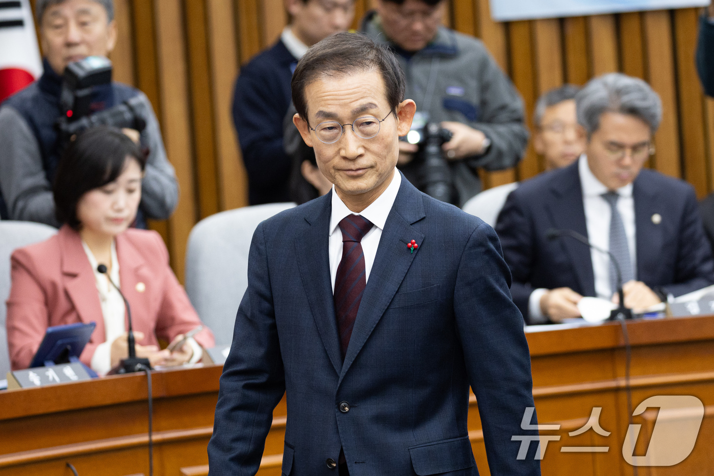 (서울=뉴스1) 유승관 기자 = 김호철 감사원장 후보자가 29일 서울 여의도 국회에서 열린 인사청문회에서 선서문을 정점식 위원장에게 전달한 후 자리로 이동하고 있다. 2025.12 …