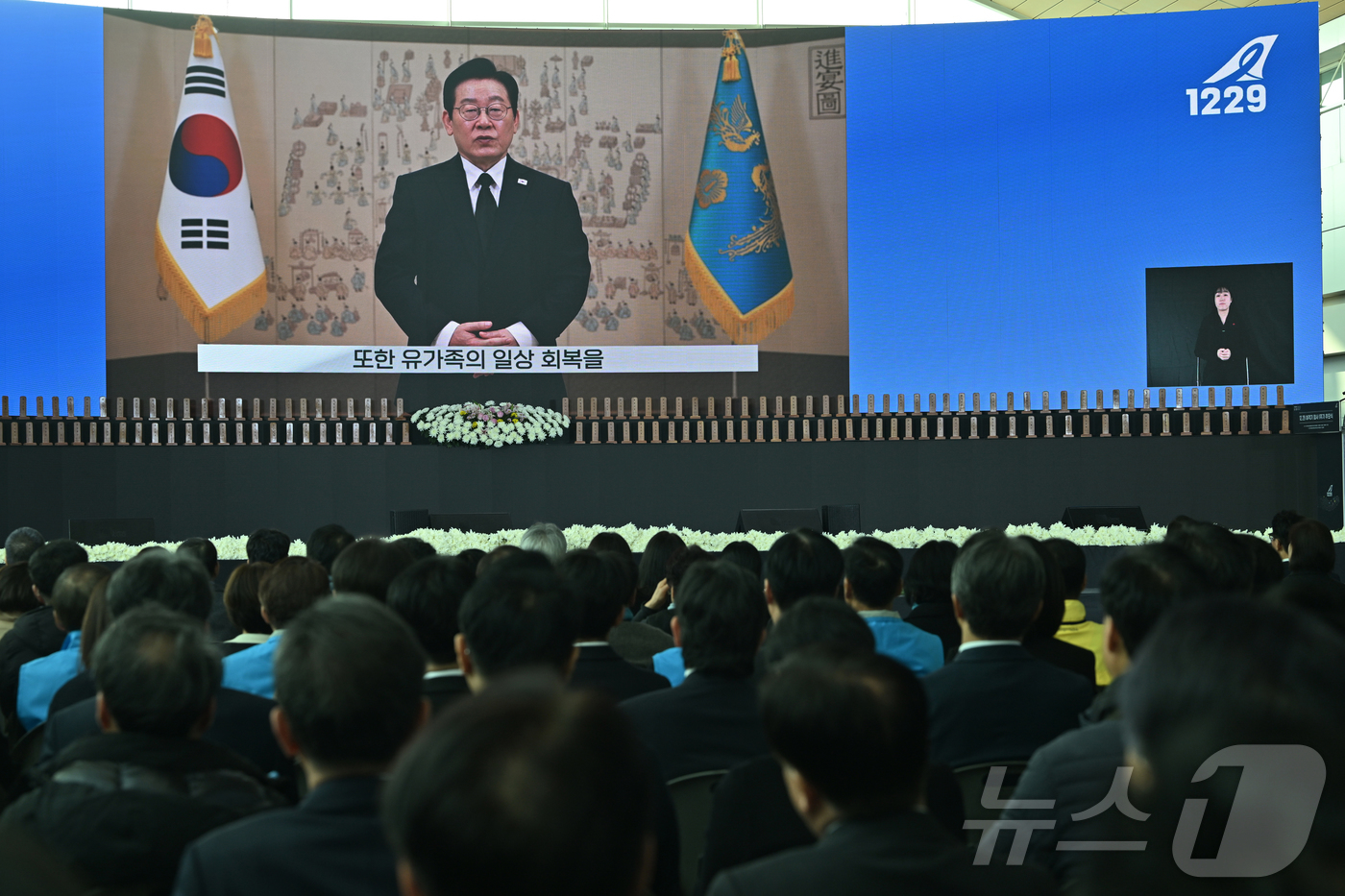 (무안=뉴스1) 사진공동취재단 = 12·29 제주항공 여객기 참사 1주기인 29일 오전 전남 무안국제공항에서 추모식에서 이재명 대통령의 영상 추모사가 공개되고 있다. 2025.12 …