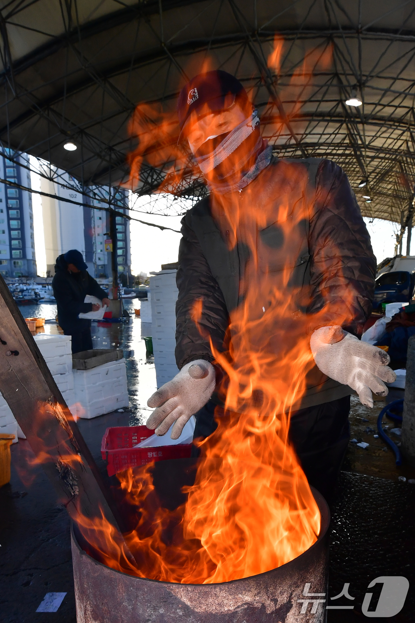 (포항=뉴스1) 최창호 기자 = 경북 포항 지역 아침기온이 영하권까지 떨어진 3일 포항시 죽도어시장에서 상인들이 장작불에 몸을 녹이고 있다. 2025.12.3/뉴스1