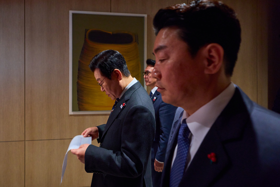 자료 보며 이동하는 이재명 대통령