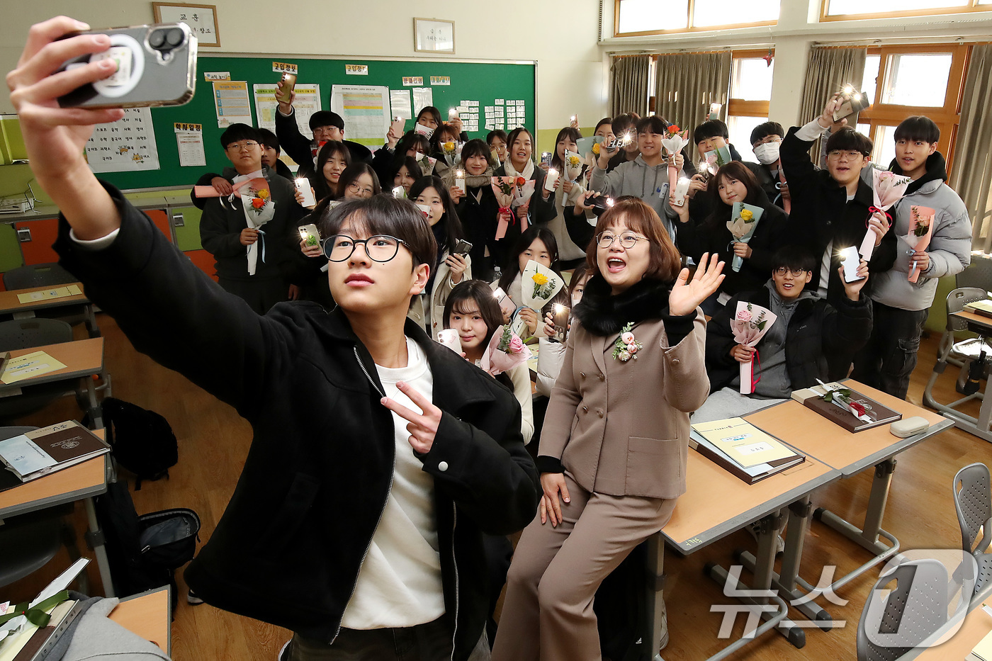 (대구=뉴스1) 공정식 기자 = 5일 대구 수성구 대구동중학교에서 열린 제63회 졸업식에 참석한 졸업생들이 3학년 교실에서 담임 선생님과 기념사진을 찍고 있다. 2025.2.5/뉴 …