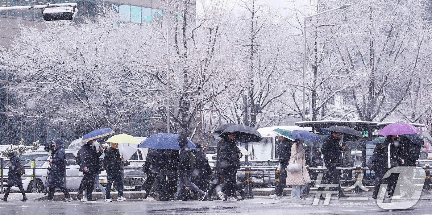 본문 이미지 -   대설주의보가 발효된 18일 오전 서울 광화문네거리에서 시민들이 출근길 발걸음을 옮기고 있다. 2025.3.18/뉴스1 ⓒ News1 박지혜 기자