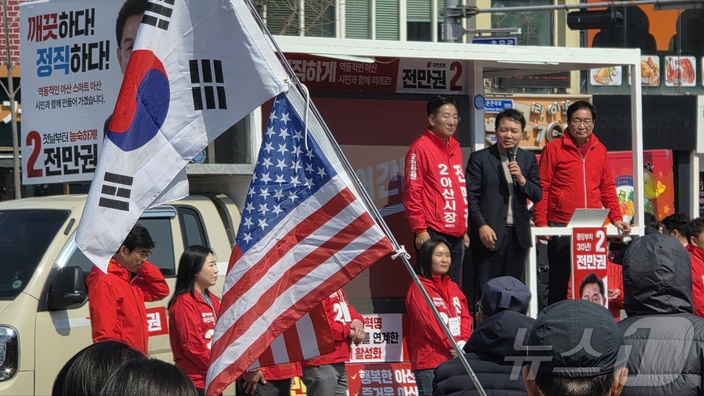 (아산=뉴스1) 이시우 기자 = 4·2아산시장 재선거에 출마한 국민의힘 전만권 후보의 출정식에서 한 지지가 태극기와 성조기를 들고 응원하고 있다. 2025.3.20/뉴스1