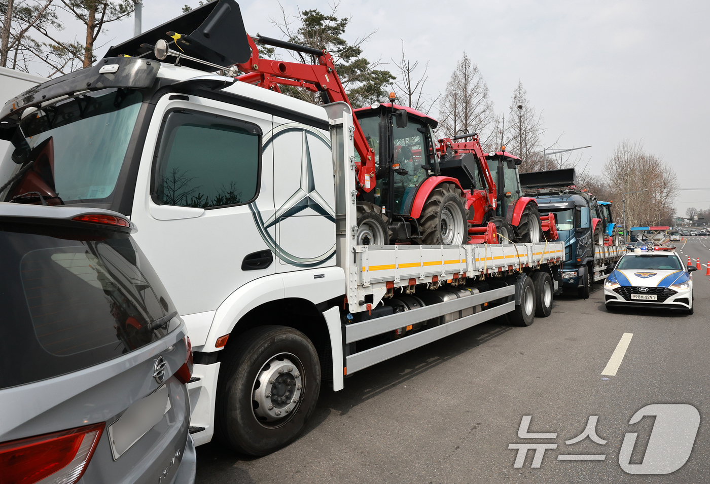 (서울=뉴스1) 김진환 기자 = 25일 서울 강남구 세곡동사거리에서 경찰 차량이 전국농민회총연맹(전농) 소속 트랙터의 진입을 막고 있다.전농은 이날 서울 서초구 남태령고개에서 윤석 …