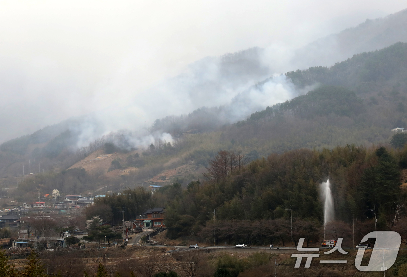 (산청=뉴스1) 윤일지 기자 = 경남 산청·하동 산불 일주일째인 27일 오후 지리산과 인접한 산청군 시천면 동당마을 일대에서 소방당국이 산불 확산 차단을 위해 물을 뿌리고 있다. …
