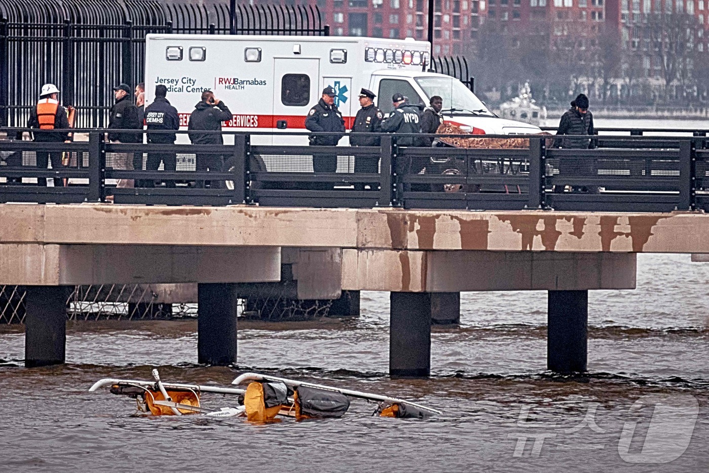 (뉴욕 AFP=뉴스1) 우동명 기자 = 10일(현지시간) 뉴욕의 허드슨 강에 추락해 탑승자 6명 전원이 숨진 헬기셔 경찰이 희생자의 시신을 옮기고 있다. 2025.04.11ⓒ AF …