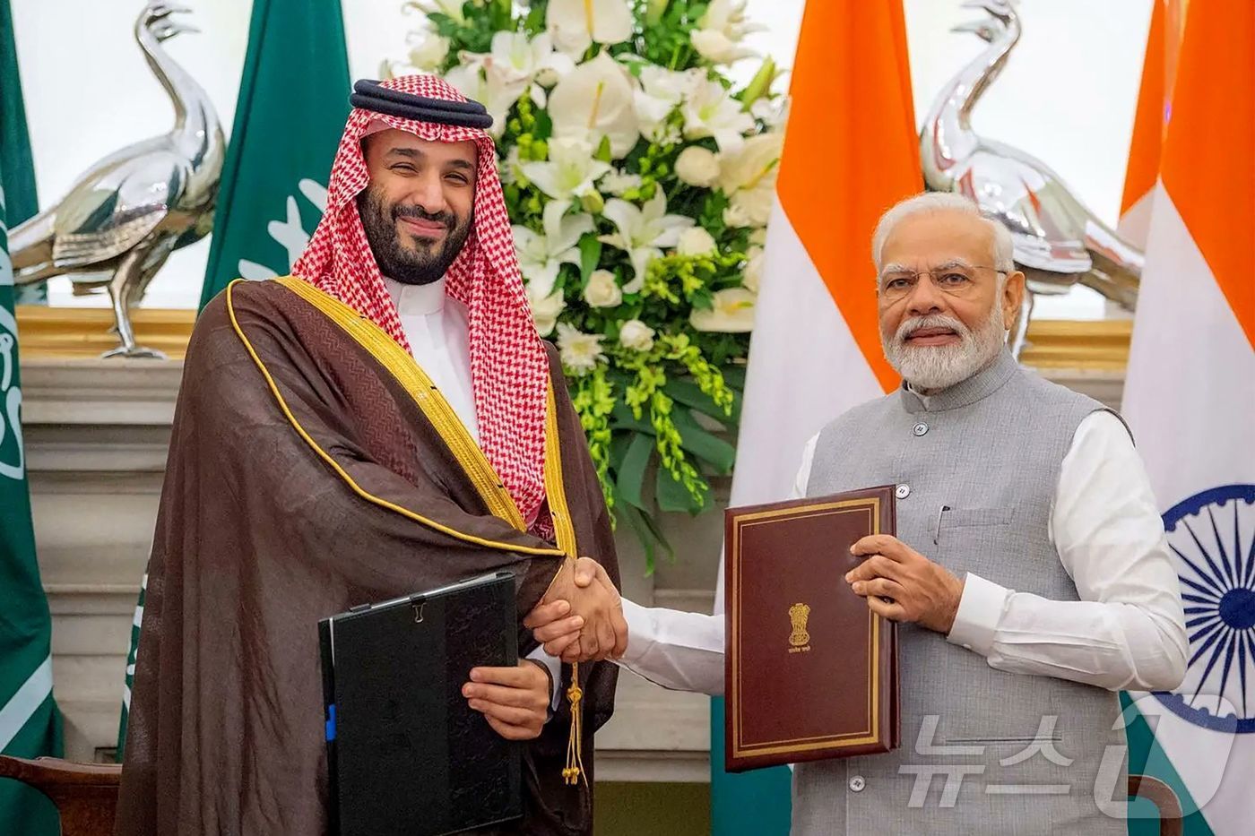 (제다 AFP=뉴스1) 우동명 기자 = 나렌드라 모디 인도 총리와 빈 살만 사우디아라비아 왕세자가 22일 (현지시간) 제다 왕궁에서 조인식을 마친 뒤 악수를 하고 있다. 2025. …