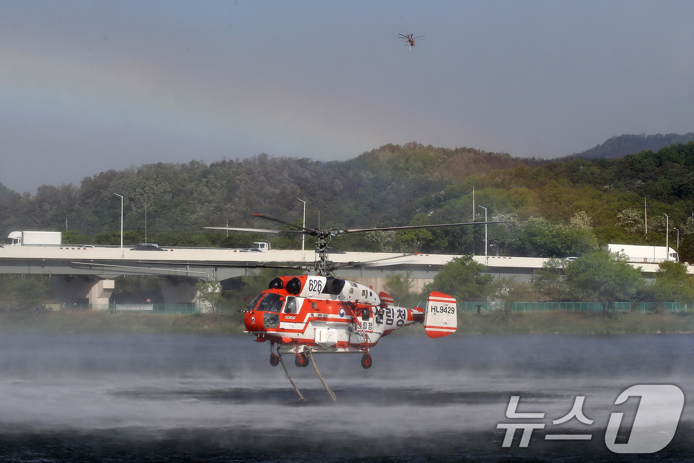 (대구=뉴스1) 공정식 기자 = 대구 북구 함지산 산불 이틀째인 29일 오전 현장에 투입된 산불 진화 헬기가 화재현장 인근 금호강에서 물을 채우고 있다. 2025.4.29/뉴스1