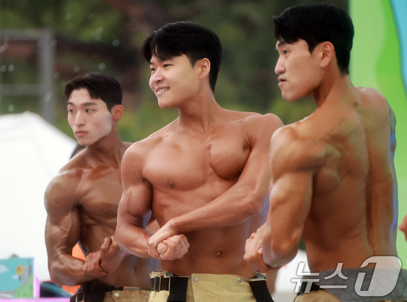 (서울=뉴스1) 김진환 기자 = 1일 서울 영등포구 여의도공원 문화의마당에서 열린 몸짱소방관 선발대회에 출전한 소방관들이 근육을 뽐내기에 앞서 준비하고 있다. 2025.5.1/뉴스 …