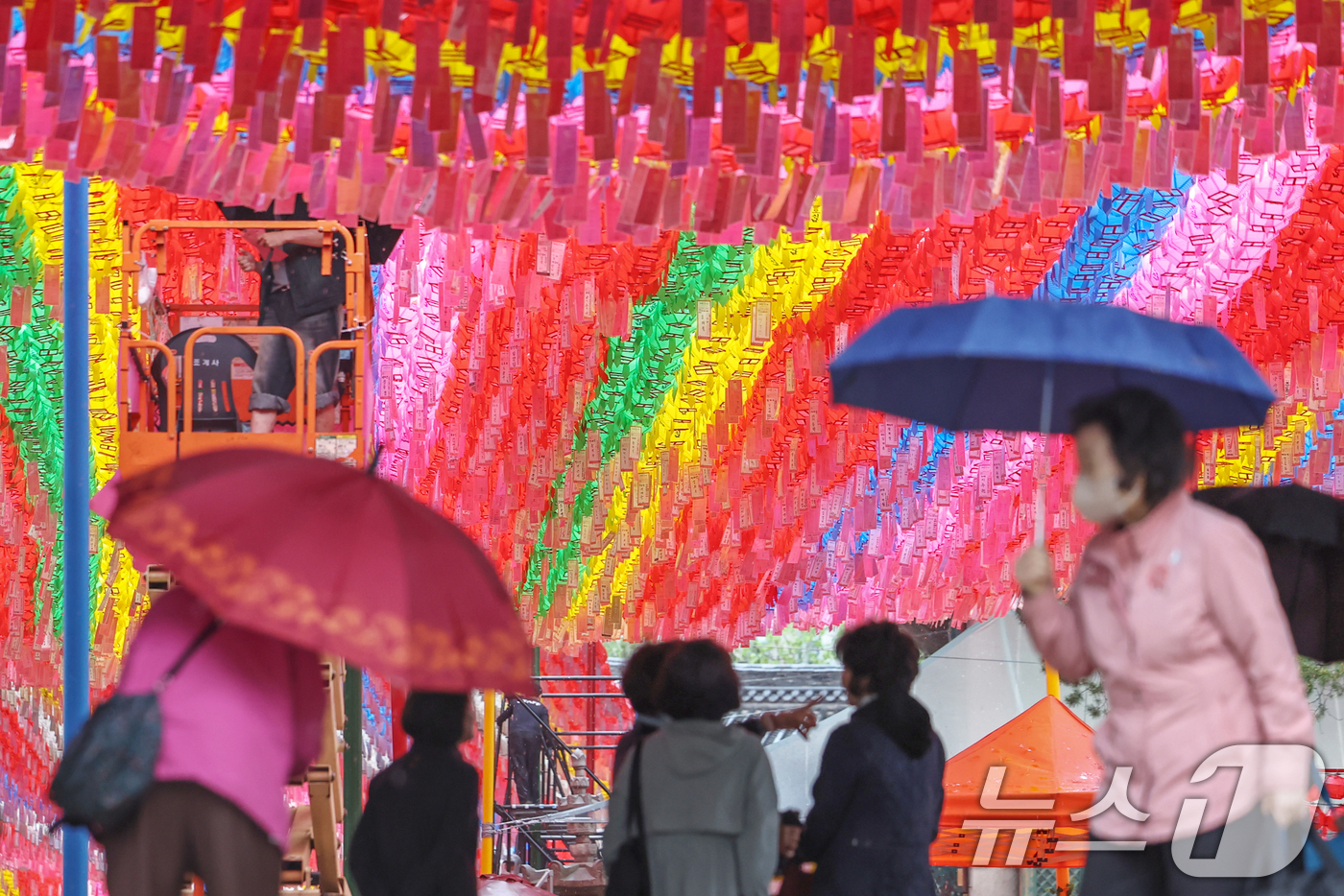 (서울=뉴스1) 민경석 기자 = 서울을 비롯한 수도권 일대에 비가 내린 1일 서울 종로구 조계사 일주문 아래에서 시민들이 비를 피하며 연등을 바라보고 있다. 2025.5.1/뉴스1 …