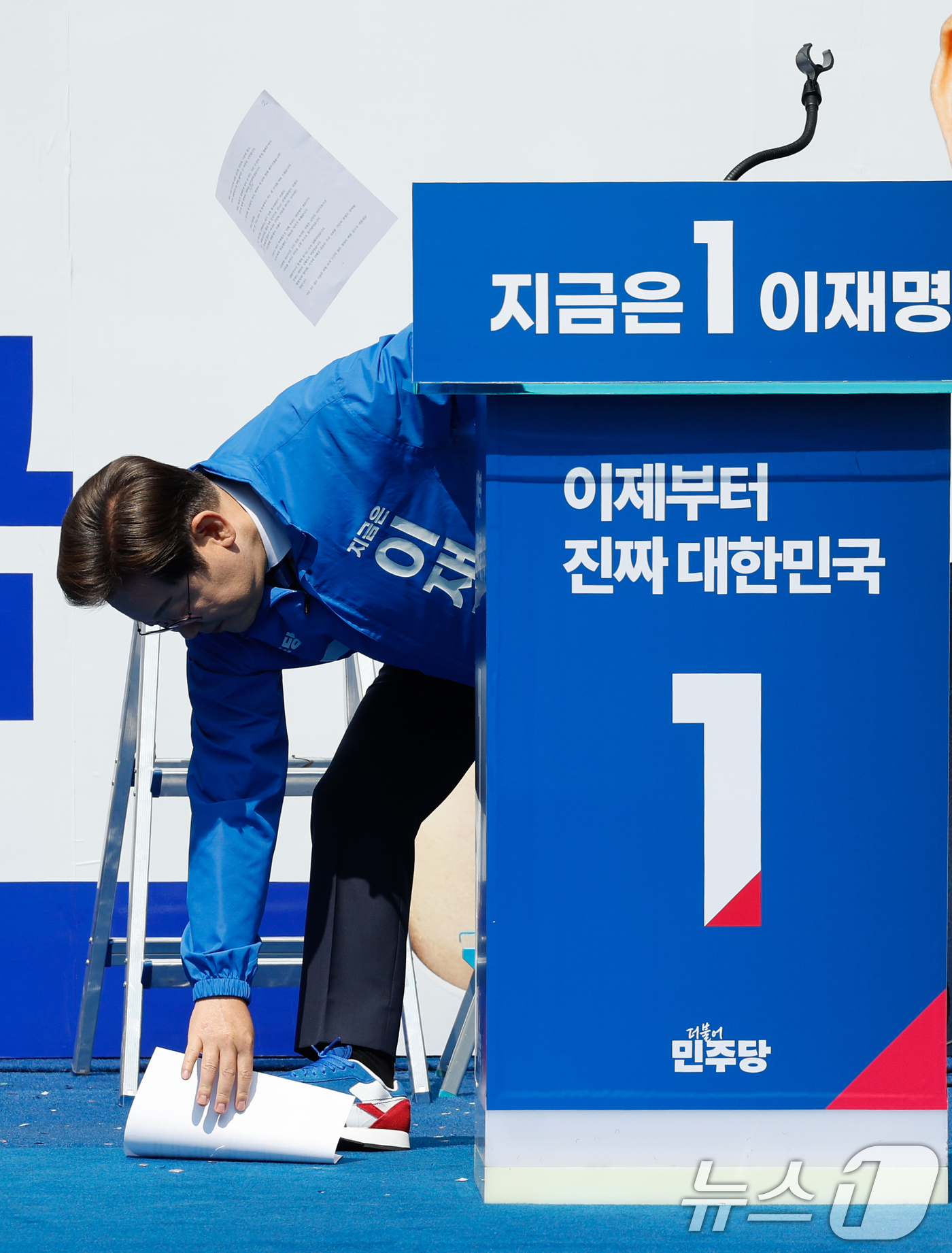 (서울=뉴스1) 안은나 기자 = 이재명 더불어민주당 대통령 후보가 공식 선거운동 첫날인 12일 오전 서울 중구 청계광장에서 열린 출정식에서 연설을 하기 전 바람에 원고가 흩날리자 …