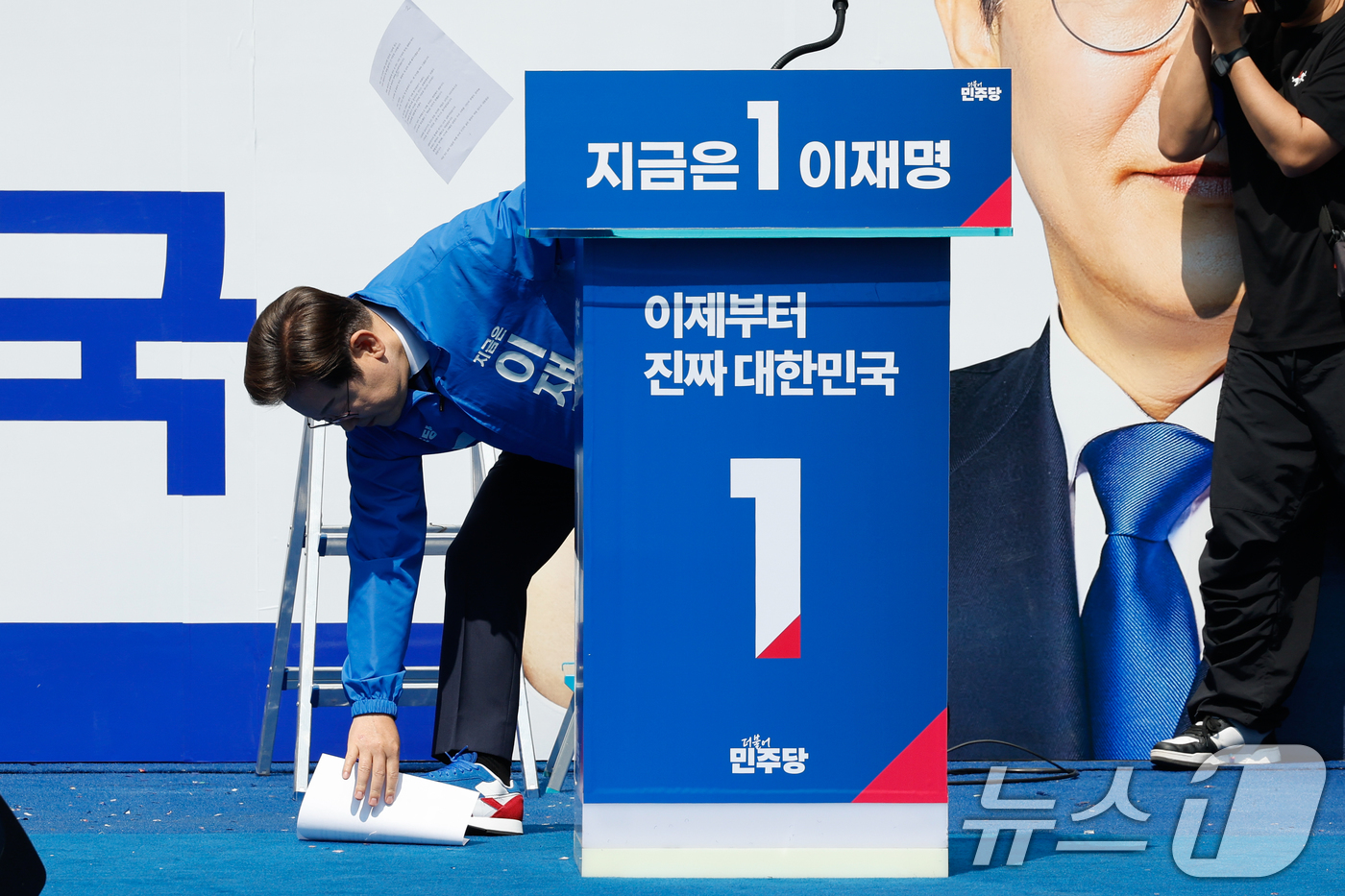 (서울=뉴스1) 안은나 기자 = 이재명 더불어민주당 대통령 후보가 공식 선거운동 첫날인 12일 오전 서울 중구 청계광장에서 열린 출정식에서 연설을 하기 전 바람에 원고가 흩날리자 …