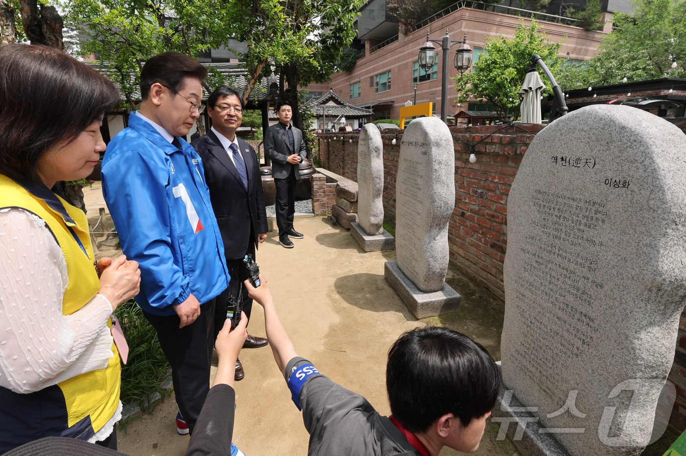 (대구=뉴스1) 안은나 기자 = 이재명 더불어민주당 대선 후보가 13일 대구 중구 시인 이상화 고택을 방문해 해설사의 설명을 들으며 ‘역천'을 읽고 있다. (공동취재) 2025.5 …