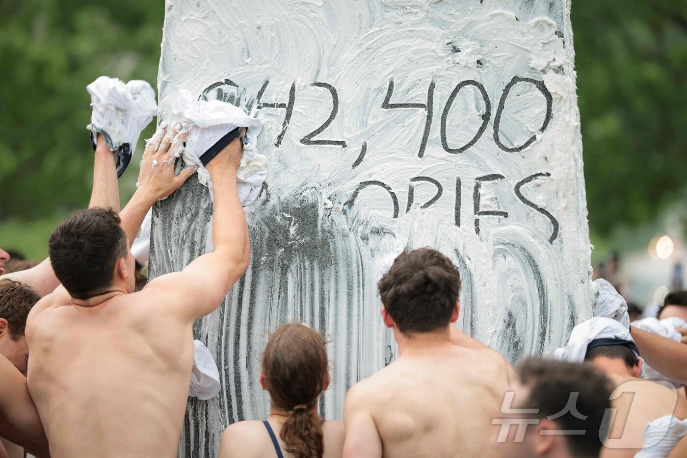 본문 이미지 - 미국 해군사관학교에서 사관생도들이 14일(현지시간) 미국 메릴랜드 주 아나폴리스 미 해군 사관학교에서 '딕시 컵'을 떨어뜨리기 위해 인간 피라미드를 만들어 헌던 기념물 꼭대기에 오르고 있다. ⓒ AFP=뉴스1