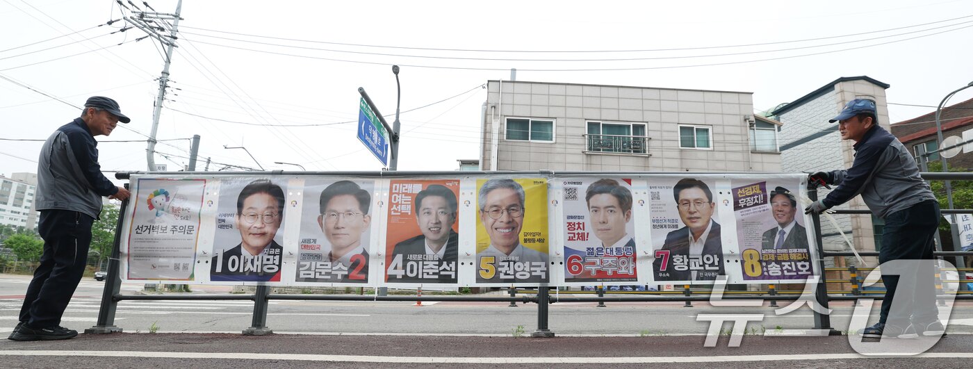 본문 이미지 - 15일 경기 수원시 권선구의 한 거리에서 관계자들이 제21대 대통령선거 후보자들 선거 벽보를 부착하고 있다. 2025.5.15/뉴스1 ⓒ News1 김영운 기자