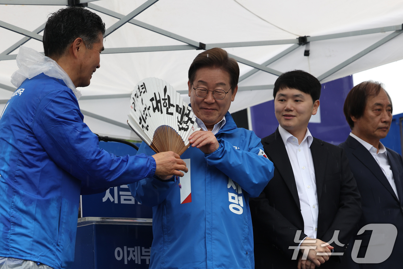 (전주=뉴스1) 이재명 기자 = 이재명 더불어민주당 대통령 후보가 16일 오후 전북 전주시 전북대학교 앞에서 '이제부터 진짜 대한민국'이 적힌 전주 한지 부채(합죽선)를 들어보이고 …