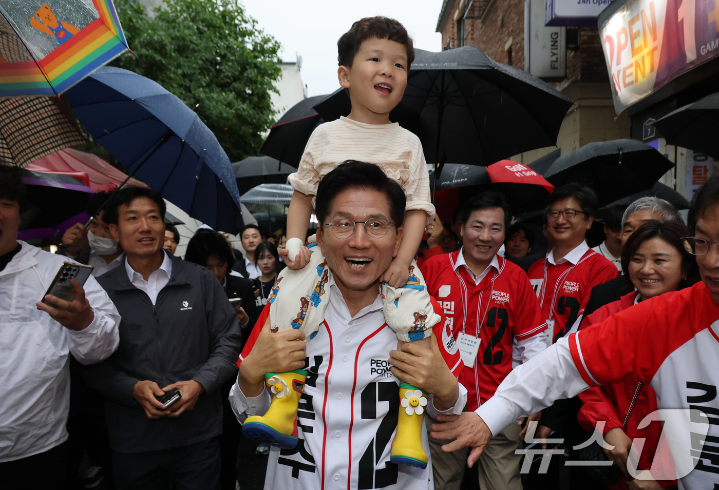 (대전=뉴스1) 이광호 기자 = 김문수 국민의힘 대통령 후보가 16일 오후 대전 중구 으능정이거리에서 한 시민의 아이를 목마 태우고 유세차량으로 이동하고 있다. 2025.5.16/ …