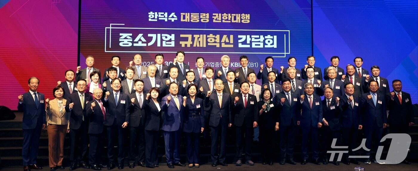 본문 이미지 - 오영주 중소벤처기업부 장관&#40;앞줄 왼쪽 9번째부터&#41;과 한덕수 당시 국무총리, 김기문 중소기업중앙회장이 &#39;중소기업 규제 혁신 간담회&#39;에서 기념 촬영을 하고 있다.&#40;중소기업중앙회 제공&#41;