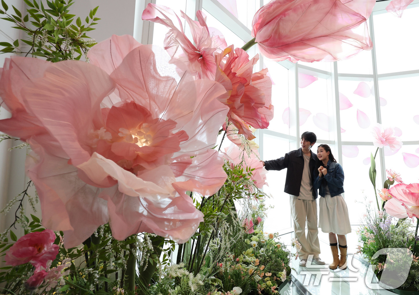 (서울=뉴스1) 박지혜 기자 = 20일 서울 송파구 롯데월드타워 전망대 서울스카이에 마련된 플라워 체험형 공간인 '블루밍 유니버스: 빅플라워' 앞에서 모델들이 포즈를 취하고 있다. …