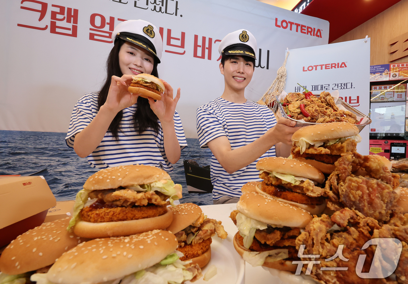 (서울=뉴스1) 장수영 기자 = 21일 서울 롯데리아 동대문역사문화공원역점에서 모델들이  '크랩 얼라이브 버거'를 소개하고 있다.롯데리아는 통째로 먹을 수 있는 소프트쉘 게 한 마 …