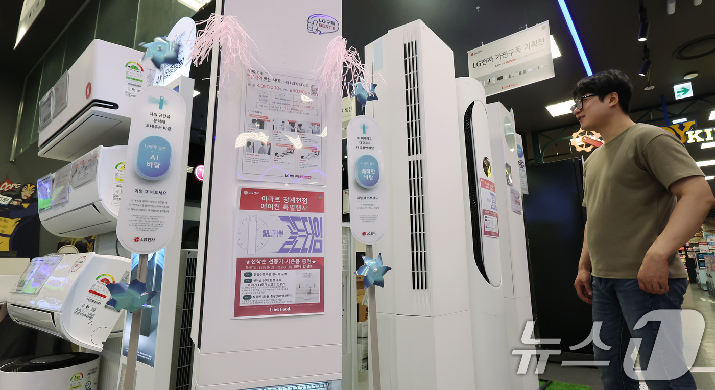 (서울=뉴스1) 장수영 기자 = 21일 서울 중구 이마트 청계천점 일렉트로 마트를 찾은 시민이 에어컨을 살펴보고 있다.최근 잦은 비로 인한 습한 날씨와 이른 무더위가 연달아 나타나 …