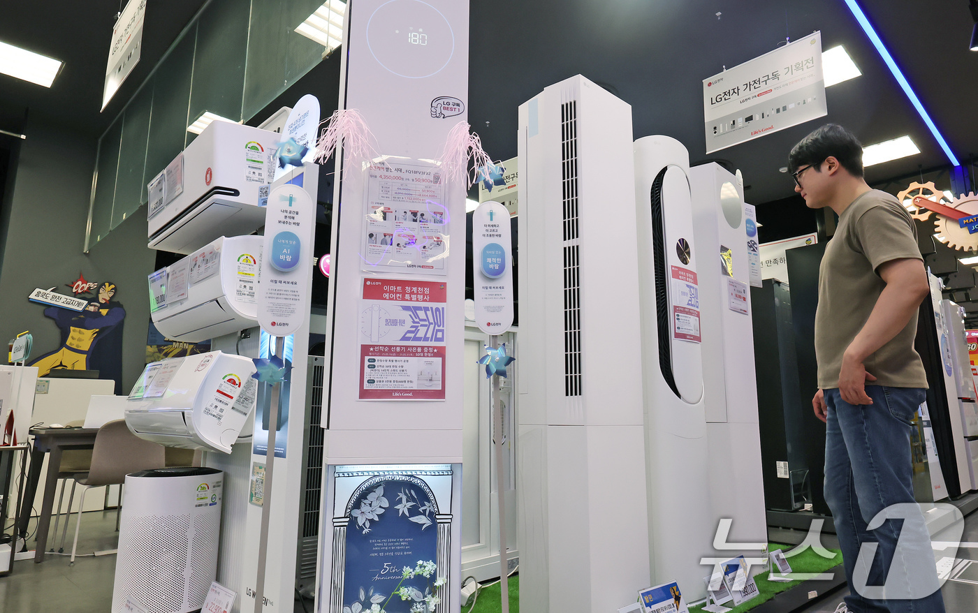 (서울=뉴스1) 장수영 기자 = 21일 서울 중구 이마트 청계천점 일렉트로 마트를 찾은 시민이 에어컨을 살펴보고 있다.최근 잦은 비로 인한 습한 날씨와 이른 무더위가 연달아 나타나 …