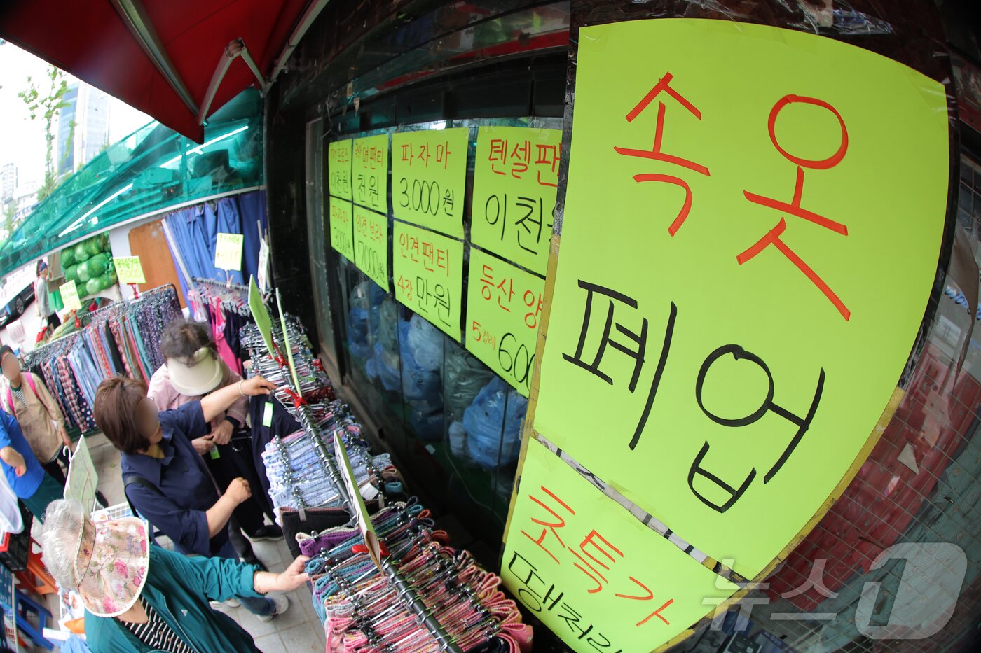 본문 이미지 - 올해 문을 닫는 자영업자 수가 100만을 넘을 것이란 전망이 나온 23일 서울 서대문구 홍제동의 &#39;속옷 폐업&#39;을 붙인 가게에서 주민 등이 물건을 고르고 있다. 2025.5.23/뉴스1 ⓒ News1 박정호 기자