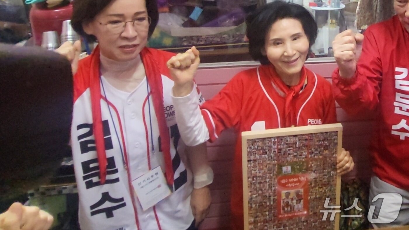 본문 이미지 - 24일 김문수 국민의힘 대통령 후보 배우자 설난영 여사가 대구 중구 서문시장에 있는 칼국숫집에서 중남구 당협협의회가 전달한 액자를 전달받고 기념 사진을 촬영하고 있다. 2025.5.24/뉴스1 ⓒ News1 이성덕 기자