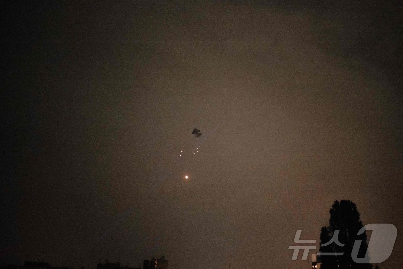 (키이우 AFP=뉴스1) 우동명 기자 = 25일(현지시간) 우크라이나 키이우 상공에서 러시아 군의 드론이 격추돼 파편이 떨어 지는 모습이 보인다. 2025.05.26ⓒ AFP=뉴스 …