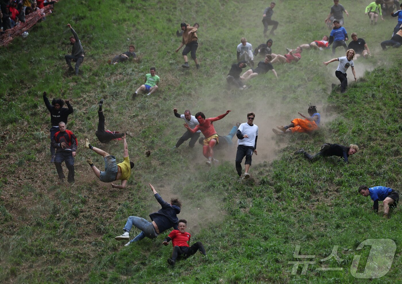 본문 이미지 - 26일(현지시간) 영국 브록웍스의 쿠퍼스 힐에서 열린 '구르는 치즈 잡기' 대회에서 참가자들이 치즈를 쫒아 언덕을 내려가고 있다. ⓒ 로이터=뉴스1
