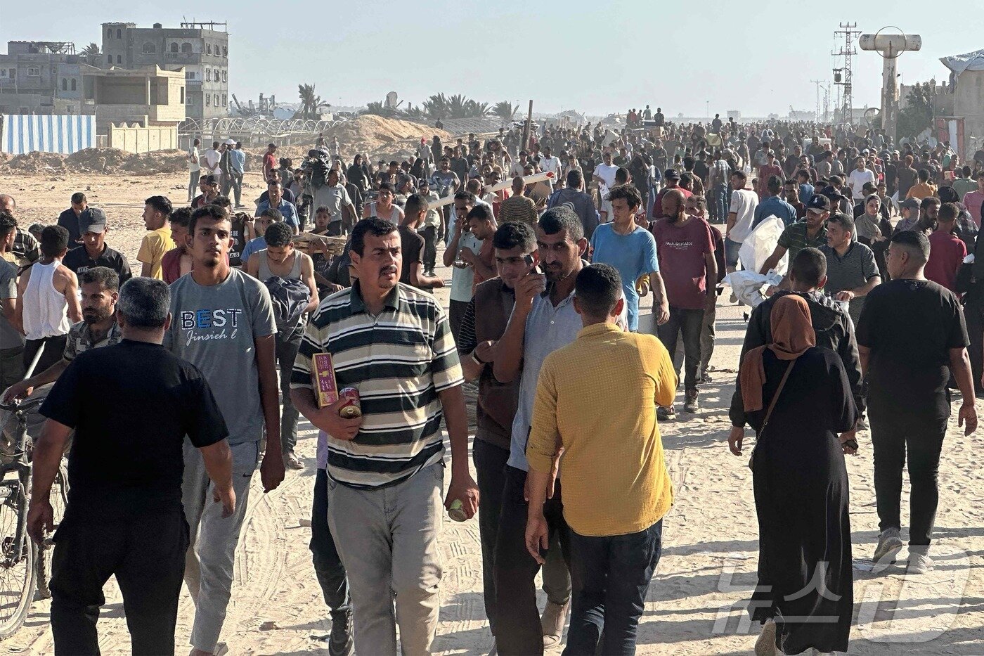 본문 이미지 - 가자지구 남부에서 27일(현지시간) 가자인도주의재단(GHF)의 구호품 배급이 시작돼 수천명이 몰려들었다. 2025.05.27. ⓒ AFP=뉴스1