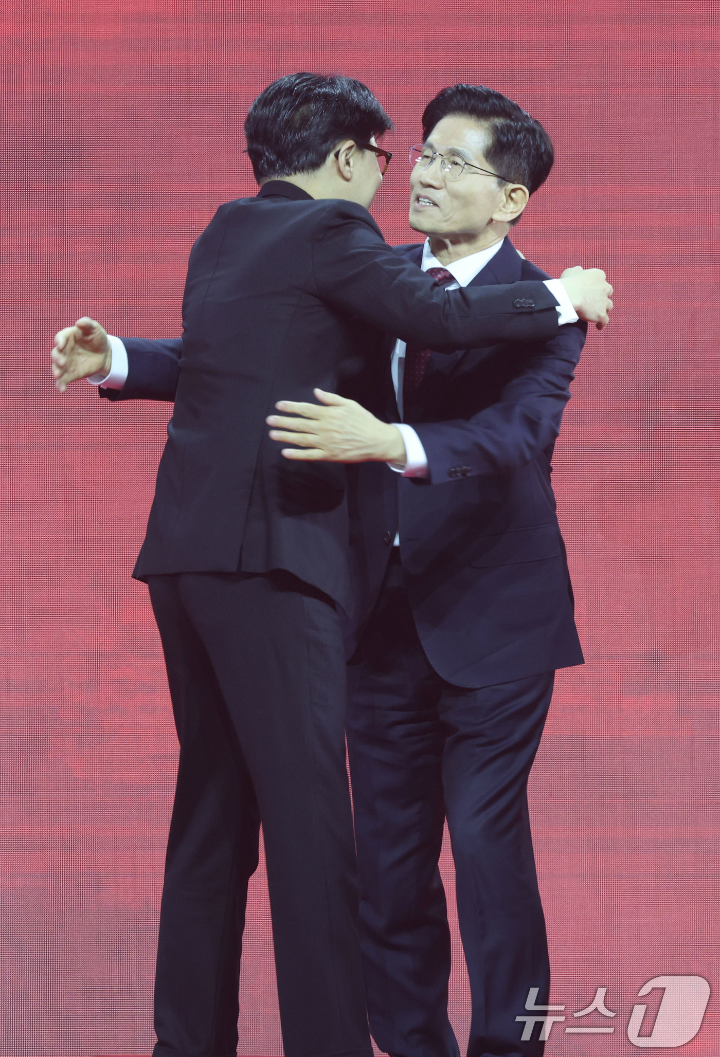 (고양=뉴스1) 이광호 기자 = 한동훈(왼쪽), 김문수 국민의힘 대선 경선 후보가 3일 경기 고양시 킨텍스에서 열린 5차 전당대회에서 당원들에게 인사한 뒤 포옹하고 있다. 2025 …
