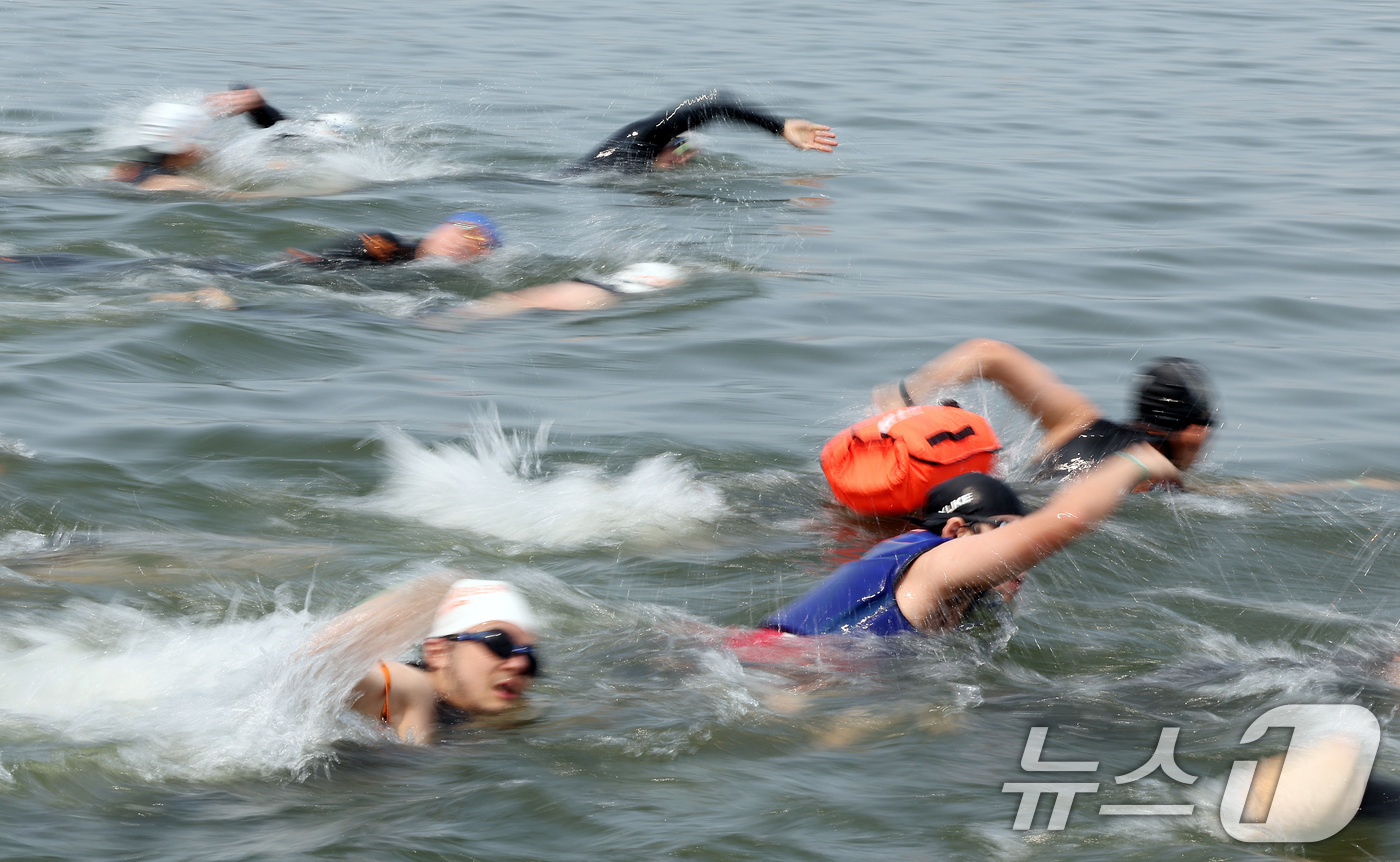 (서울=뉴스1) 이동해 기자 = 30일 오전 서울 송파구 잠실대교 남단에서 열린 제2회 쉬엄쉬엄 한강 3종 축제 상급자코스 수영 1km 코스에서 참가자들이 한강에 입수해 수영하고 …