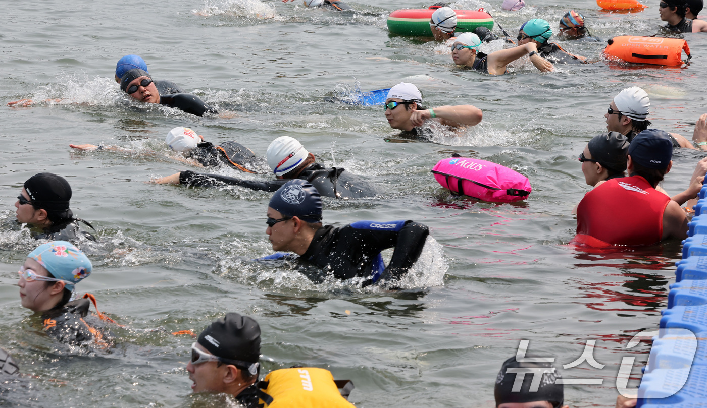 (서울=뉴스1) 이동해 기자 = 30일 오전 서울 송파구 잠실대교 남단에서 열린 제2회 쉬엄쉬엄 한강 3종 축제 상급자코스 수영 1km 코스에서 참가자들이 한강에 입수해 수영하고 …