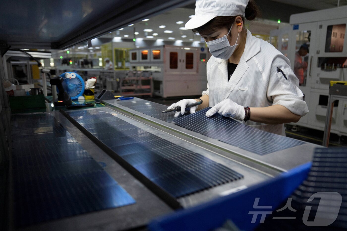 본문 이미지 - 중국 허페이의 한 태양광 패널 공장에서 한 여성이 작업중이다. 2024. 05.16. ⓒ 로이터=뉴스1