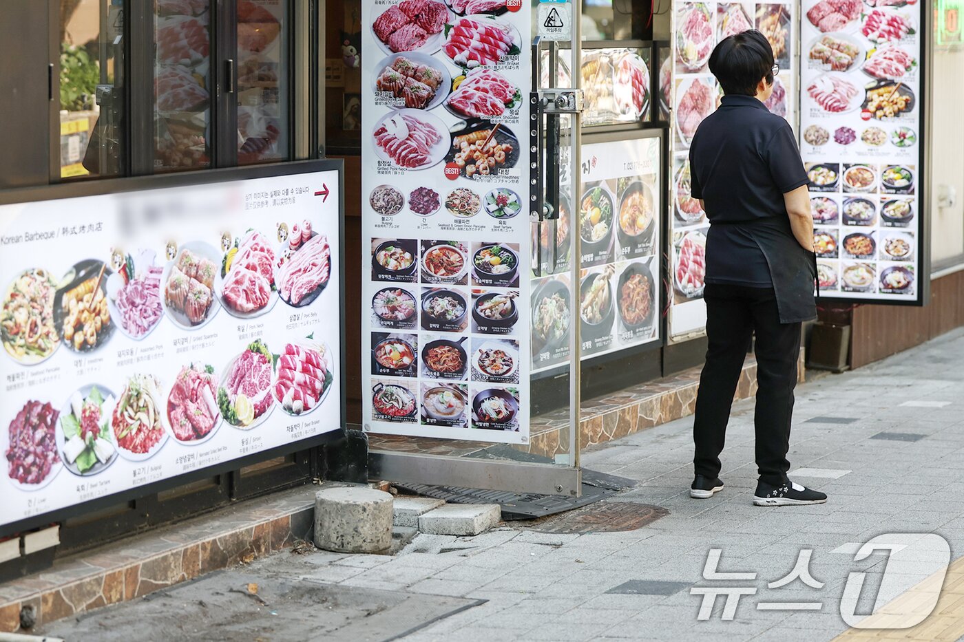 본문 이미지 - 서울 중구 명동의 한 식당에서 한 자영업자가 손님을 기다리고 있다. 2025.6.12/뉴스1 ⓒ News1 민경석 기자