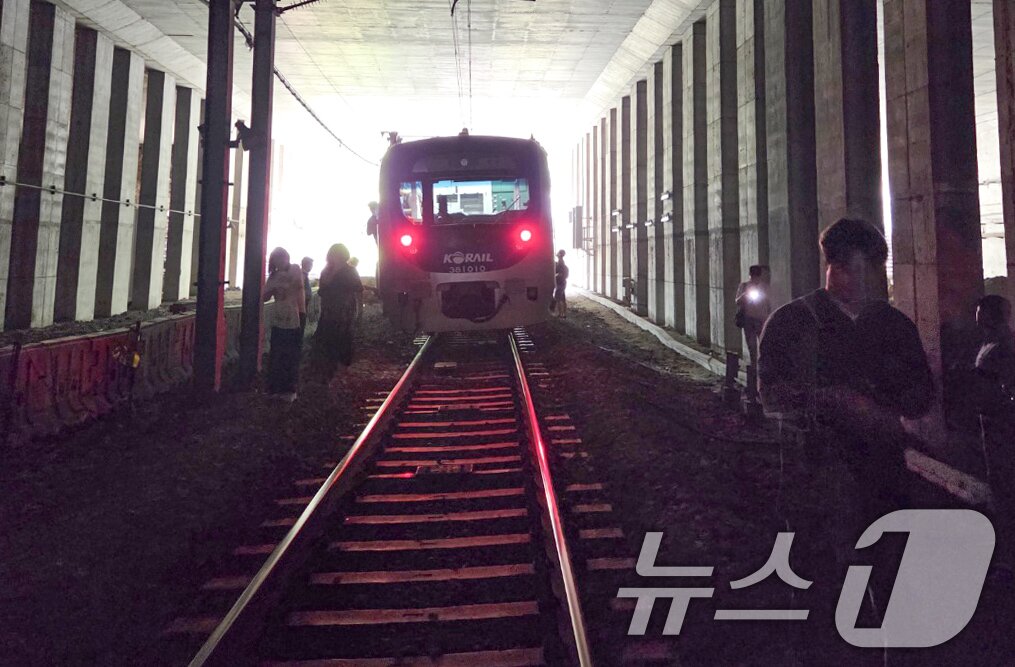 본문 이미지 - 13일 오전 경의중앙선 신촌역 인근에서 사다리차 전도사고가 발생해 가좌역~신촌역 구간이 양방향 통제된 가운데 서울역행 경의중앙선 열차에 탑승한 승객들이 열차에서 내려 선로를 따라 대피하고 있다. &#40;독자 제공, 재판매 및 DB금지&#41;