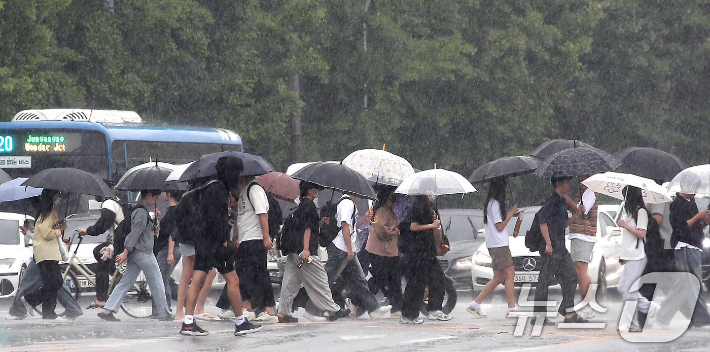 (대구=뉴스1) 공정식 기자 = 13일 오후 대구 달서구 계명대 성서캠퍼스 앞 도로에서 장맛비를 피해 우산을 쓴 시민들이 발걸음을 재촉하고 있다. 2025.6.13/뉴스1