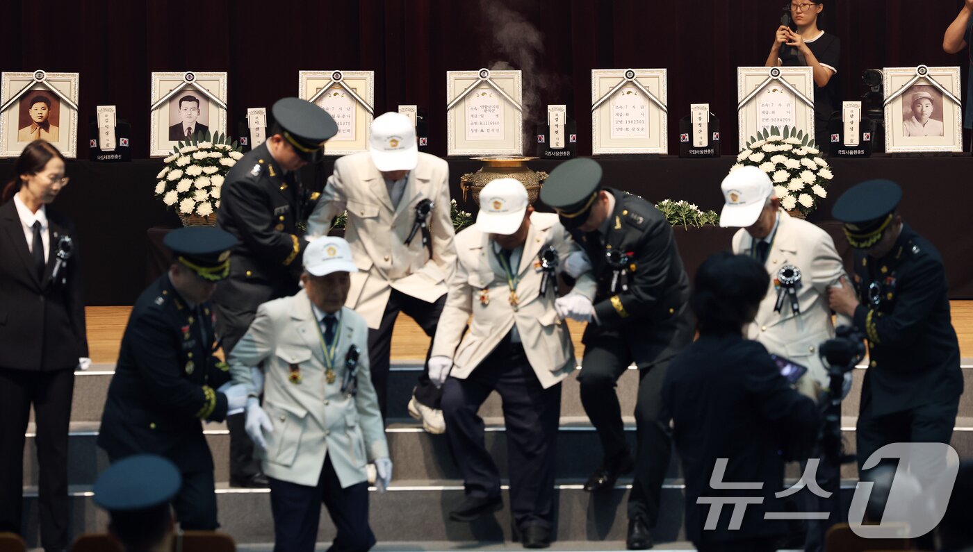 본문 이미지 - 6·25전쟁 75주년을 일주일 앞둔 18일 서울 동작구 국립서울현충원 현충관에서 거행된 6·25전쟁 전사자 발굴 유해 합동 안장식에서 참전 유공자들이 헌화 후 단상을 내려오고 있다. 2025.6.18/뉴스1 ⓒ News1 오대일 기자