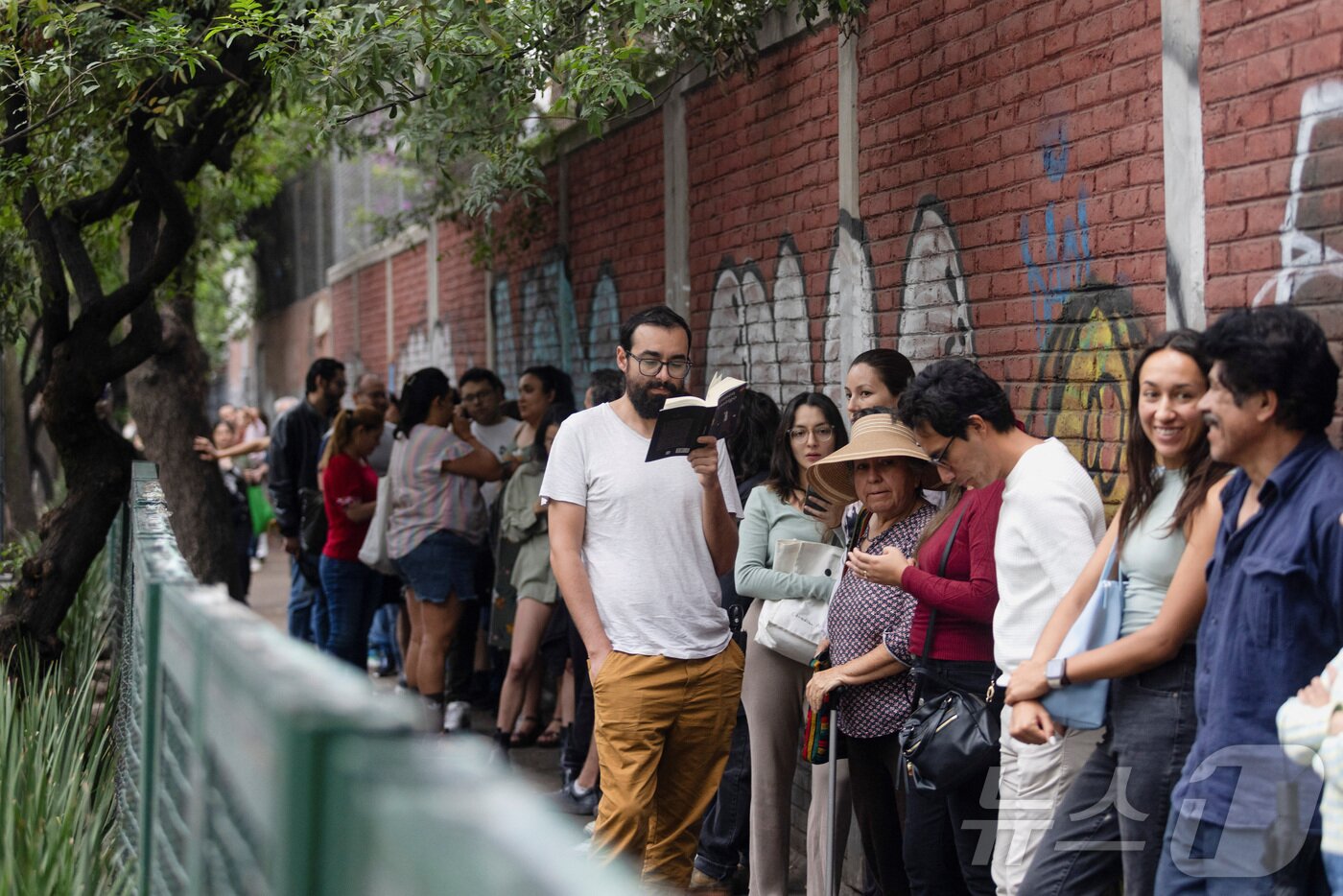본문 이미지 - 1일(현지시간) 멕시코시티 투표소에서 판사 선출 투표를 하기 위해 유권자들이 길게 줄을 서고 있다. ⓒ 로이터=뉴스1