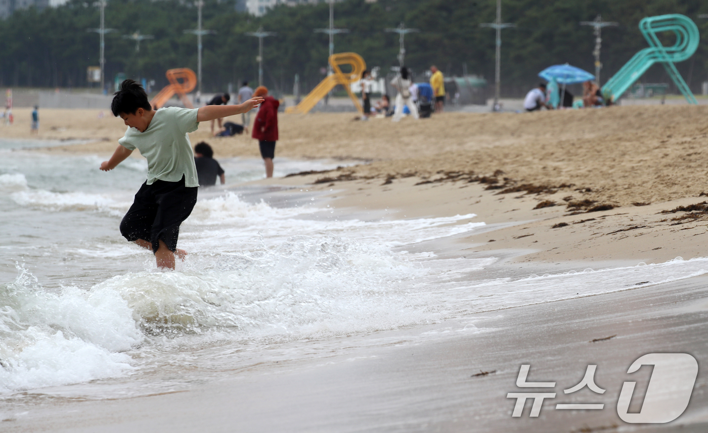 (부산=뉴스1) 윤일지 기자 = 20일 부산 해운대해수욕장에 개장을 앞두고 망루가 설치된 가운데 한 어린이가 물놀이를 즐기고 있다.부산 해운대·송정해수욕장은 오는 21일 개장하고, …