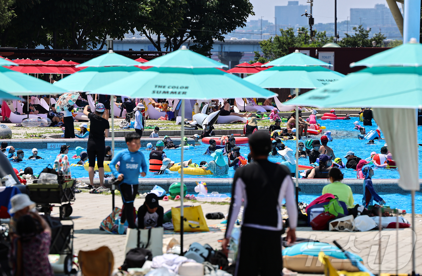 (서울=뉴스1) 김도우 기자 = 무더운 날씨를 보인 22일 서울 광진구 뚝섬야외수영장에서 시민들이 즐거운 시간을 보내고 있다.서울시는 지난 20일부터 뚝섬·여의도·잠원한강공원 수영 …