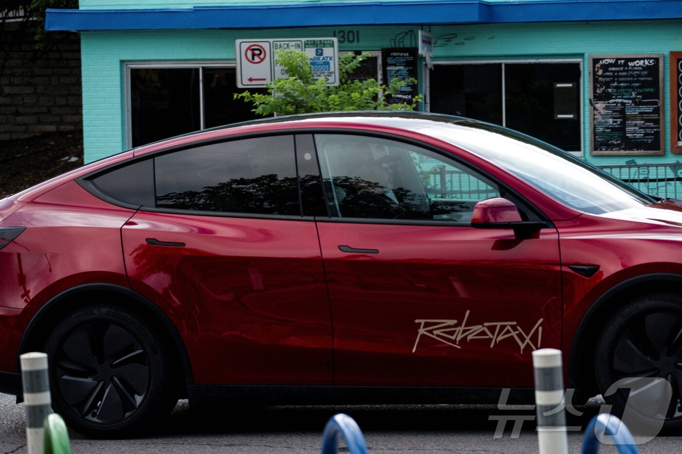 본문 이미지 - 뒷좌석에 아무도 태우지 않은 한 테슬라 로보택시가 미국 텍사스주 오스틴의 사우스콩그레스애비뉴 거리를 운행하고 있다. 2025.06.22. ⓒ 로이터=뉴스1 ⓒ News1 권영미 기자