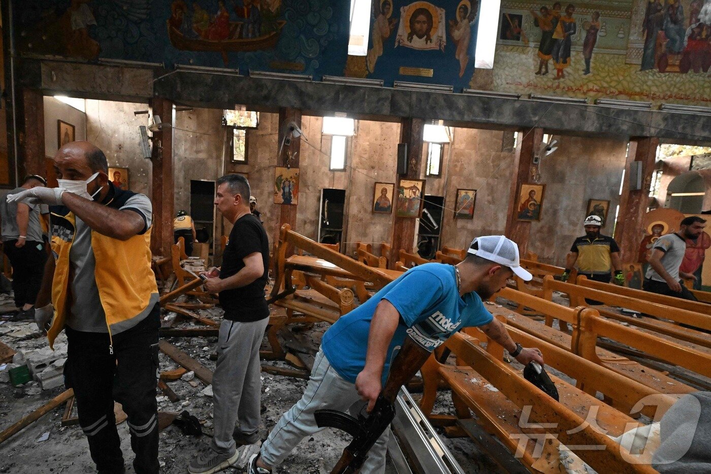 본문 이미지 - 22일&#40;현지시간&#41; 시리아 다마쿠스 드퀠라 지역의 성 엘리아스 교회에서 발생한 자살 폭탄 테러 현장에서 구조대원 등이 피해상황을 조사하고 있다.  ⓒ AFP=뉴스1