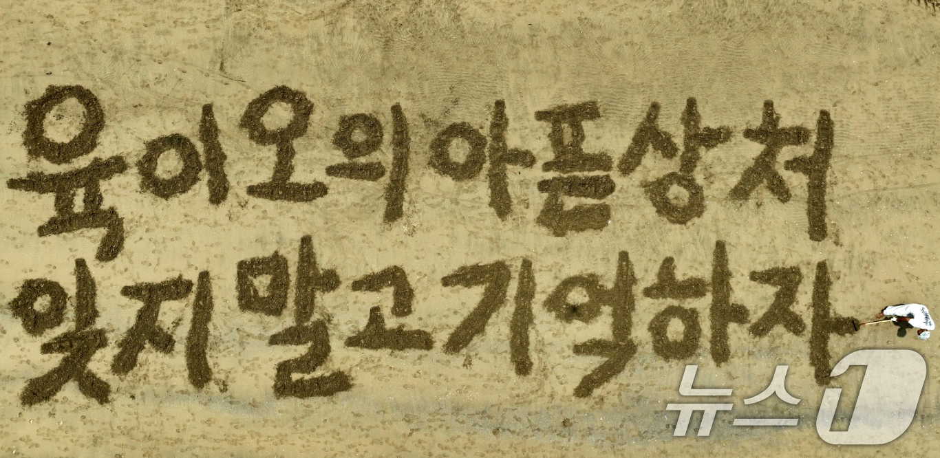 (포항=뉴스1) 최창호 기자 = 서예가 김동욱 씨가 23일 경북 포항시 송도해수욕장 백사장에서 6.25전쟁 75주년을 맞아 나라사랑 호국 퍼포먼스를 펼치고 있다. (서예가 김동욱씨 …