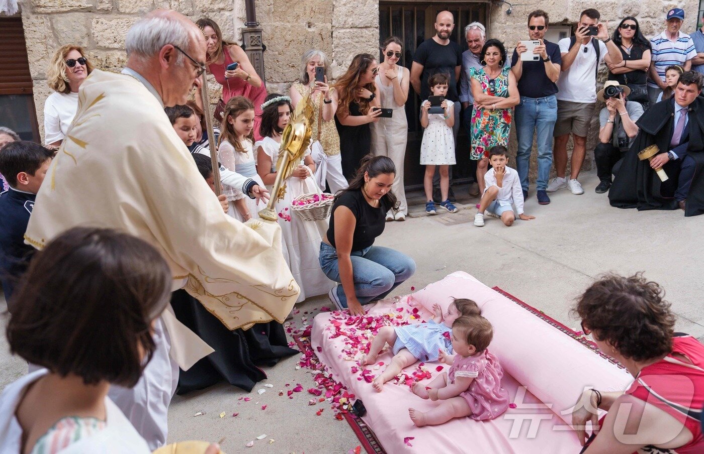 본문 이미지 - 22일(현지시간) 스페인 부르고스 인근 카스트리요 드 무르시아 마을에서 열린 '엘 콜라초(El Colacho)'축제에서 성직자가 아이들을 축복하고 있다. ⓒ AFP=뉴스1