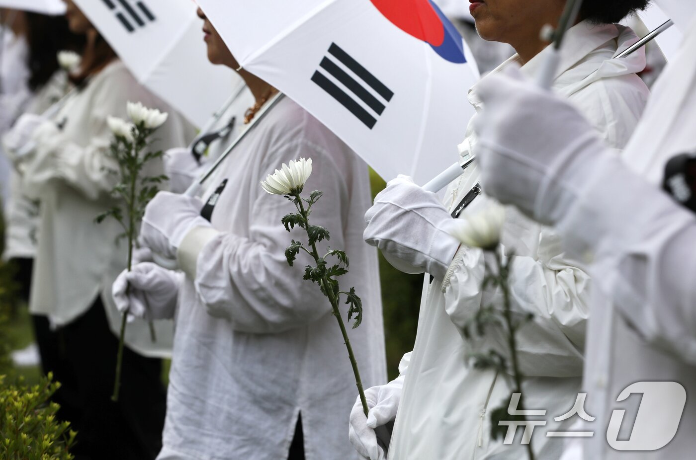 본문 이미지 - 25일 오전 부산 남구 유엔기념공원에서 열린 제75주년 6·25전쟁 참전 유엔전몰용사 추모제에서 태극기 우산을 쓴 참석자들이 유엔군 전몰장병 묘역을 참배하고 있다. 2025.6.25/뉴스1 ⓒ News1 윤일지 기자