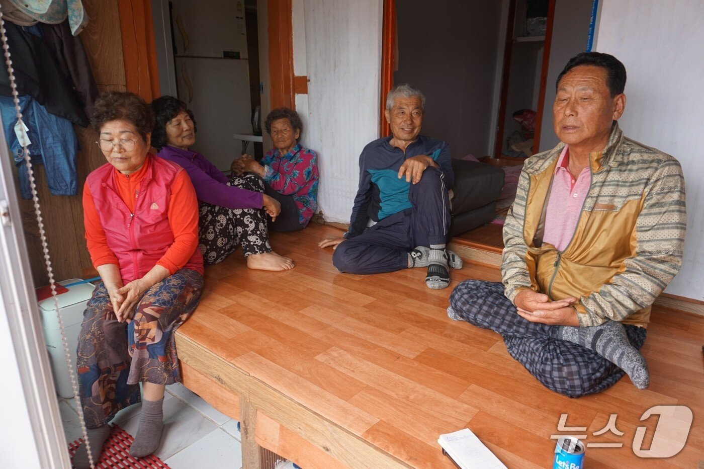 본문 이미지 - &#39;주민의 절반&#39;…김창환 이장&#40;오른쪽&#41;과 주민들이 &#39;높은자리&#39; 김용희 씨 집에 한데 모여 담소를 나누고 있다.2025.6.27/뉴스1 ⓒ News1 조영석 기자