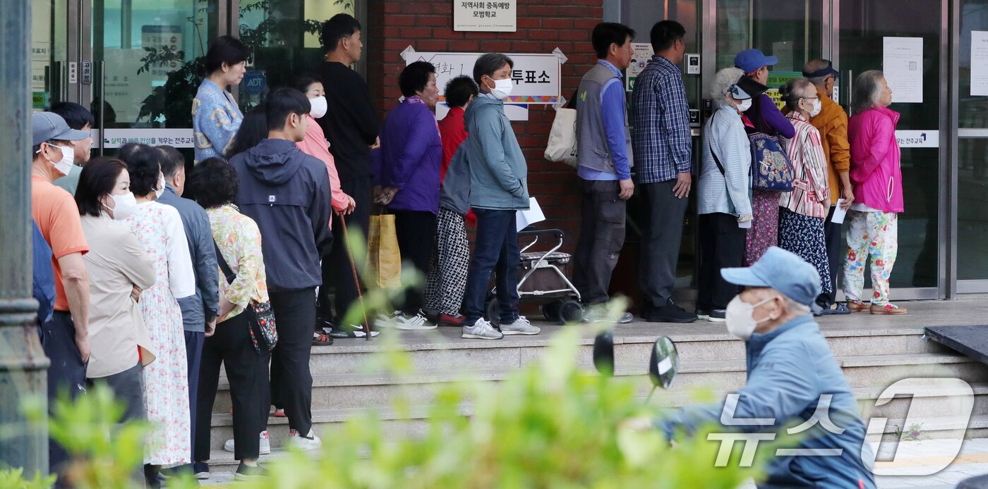 본문 이미지 - 제21대 대통령 선거 투표일인 3일 전북 전주시 남중학교에 마련된 평화1동 제2투표소를 찾은 유권자들이 투표를 하기 위해 줄지어 서 있다. 2025.6.3/뉴스1 ⓒ News1 유경석 기자